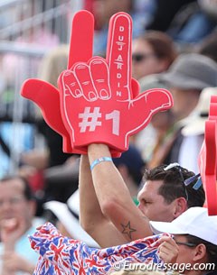 Charlotte Dujardin's biggest fan, fiancé Dean Wyatt Golding, waves his custom made foam fingers