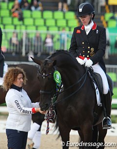 Groom Liz Geldard gives a lump of sugar to Orthilia during the prize giving