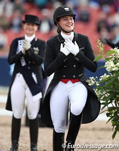 Cathrine Dufour holds her heart as she steps onto the podium to receive the bronze medal