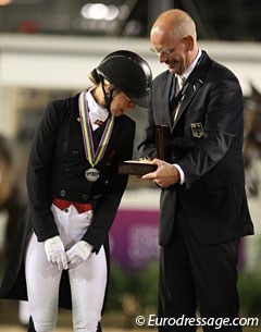 Agnete Kirk Thinggaard looks at the Longines watch which German team captain Klaus Roeser received