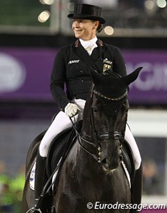 Isabell Werth smiles at the crowds as they begin clapping in her final passage line