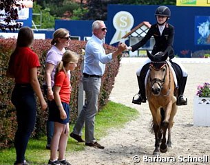 Lucie Anouk Baumgurtel gets a high five from trainer Wolfram Wittig