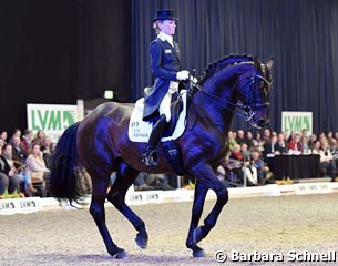 Helen Langehanenberg and Damsey, the blue colour of the score board reflecting on the horse