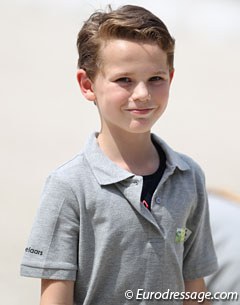 A young boy from the Rotterdam riding school picking up the test sheets after each ride