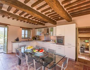 A fully equipped kitchen with dish washer, fridge and freezer, oven and a gas range with five burners