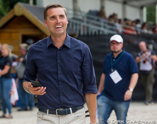 Phone in hand to do business. Andreas Helgstrand makes a clean sweep at the 2019 World Young Horse Championships in Ermelo :: Photo © Hippofoto