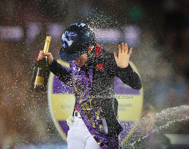 Lottie Fry getting a champagne shower after winning freestyle gold at the 2022 World Championships Dressage :: Photo © Astrid Appels