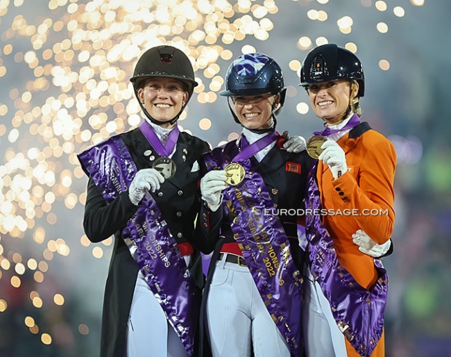 Cathrine Dufour, Charlotte Fry and Dinja van Liere on the Kur podium of the 2022 World Championships Dressage :: Photo © Astrid Appels