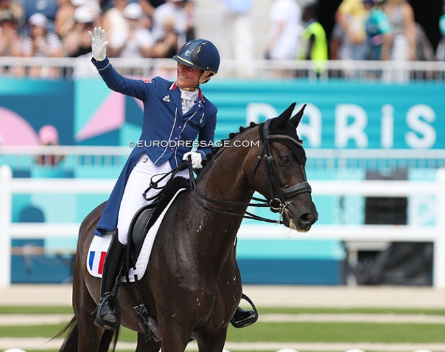 French home hero Pauline Basquin wraps her Grand Prix ride at the 2024 Olympic Games and waves to the crowds :: Photo © Astrid Appels
