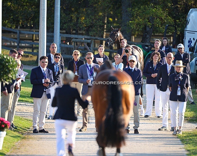 Frederic Wandres looking at Ingrid Klimke trotting up Vayron at the 2025 European Dressage Championships :: Photos © Astrid Appels