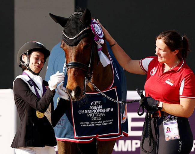 Laurentia Tan of Singapore celebrates with Hickstead after winning gold during the para dressage freestyle individual championship :: Photo © FEI/Yong Teck Lim