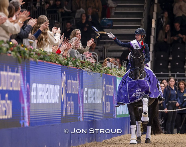 Fry throws her ribbon into the crowds during her lap of honour on Glamourdale at the 2025 CDI-W London :: Photo © Jon Stroud